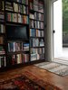 A large personal library, featuring patterned rugs, adds to the home's charm. Photo of This Oakland Bungalow Is a Treasure Trove of Thrift Store Finds and Heirlooms modern home