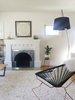 An ornate fireplace fits easily into the home's historical mood. Greenery can be found in nearly every part of the house. "No room is complete without plants," notes Young. Photo of This Oakland Bungalow Is a Treasure Trove of Thrift Store Finds and Heirlooms modern home