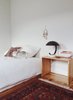 In addition to her beloved midcentury style, Young developed an appreciation for Scandinavian design while abroad in Europe in her twenties, evident in the pared-down bedroom. Photo of This Oakland Bungalow Is a Treasure Trove of Thrift Store Finds and Heirlooms modern home