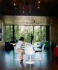 Modern home with Dining Room, Chair, and Table. In the main room, a Saarinen dining table is surrounded by four Tulip chairs, positioned to provide a mealtime panorama of the woods beyond the house. Photo 17 of New Grass Roots