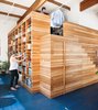 California homeowners Lynda and Peter Benoit designed a functional wooden structure to store books, keepsakes, and clothes. Photo by: Drew Kelly Photo of Modern East Bay Getaways modern home