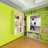 Modern home with Office, Shelves, Library Room Type, Study Room Type, and Medium Hardwood Floor. Yuko Shibata, a Tokyo architect, wanted more shelf space in her home office, so she added a plywood door with built-in bookshelves that opens into her bedroom to form a reading nook. Glimpsed from the adjacent room, the space looks larger than it actually is, thanks to the bright green walls. Photo by Ryohei Hamada. Photo of 17 Stellar Uses of Color in Home Offices