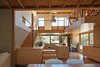 Modern home with Living Room. The home’s custom woodwork—including the movable furniture—was made by Orana Joinery and finished with plywood. Chemisys Group supplied the timber door and window finishes, as well as the timber deck outside. Photo of Furniture on Wheels Makes This Home's Kitchen Super Flexible