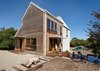Modern home with Exterior, Cabin Building Type, House, Wood Siding Material, and Gable RoofLine. An outdoor bathroom is tucked away, out of sight, in the garden. “The external fencing and outdoor shower were constructed using recycled materials from a collapsed shed near the site,” Simpson says. Photo of Furniture on Wheels Makes This Home's Kitchen Super Flexible