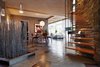 Modern home with Dining Room, Chair, Table, and Pendant Lighting. The entrance of the home features slate flagstone flooring and midcentury furniture. Photo of A Couple Reclaims Bowling Alley Floors for Their Family's Bedrooms and Even Saves Some for a Custom Bench