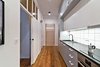 Working within the constraints of a modest budget, the design team creatively mixed custom-designed pieces with more affordable items. For example, the shared kitchen features a Franke kitchen sink and IKEA cabinetry and appliances. Framing the kitchen wall, an old gymnasium ladder adds an historical touch. The biggest challenge of the project, says Wierciński, was to “execute a low budget project with a unique original style.” Photo of Our Dorm Definitely Did Not Look Like This modern home