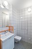Modern home with Bath Room. The bathroom features graphic eye-catching Vives floor tiles surrounded by Opoczno wall tiles and clean white plumbing fixtures. The custom-designed orange sink frame adds a whimsical pop of color. Photo of Our Dorm Definitely Did Not Look Like This
