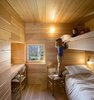 Modern home with Kids Room, Bedroom, Medium Hardwood Floor, and Bed. The kids room is outfitted with built-in bunk beds. Photo 6 of Refuge