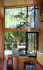 To the east, through the kitchen, it captures a luscious view of a green nikau palm grove. Photo of A Little Kiwi Beach House Beefs Up Big Time modern home