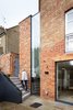 “The building was essentially rebuilt from the inside out,” Webster says. Workers gutted the 1,916-square-foot residence down to its brick shell, expanding it downward and outward to reach 3,208 square feet. Photo 2 of Lantern Home modern home
