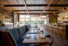 Modern home with Dining Room, Pendant Lighting, Recessed Lighting, Bar, Stools, Table, Chair, Bench, Dark Hardwood Floor, and Shelves. Hinoki and the Bird, another restaurant winner, designed by Studio MAI. Photo of The 10 Best-Designed Restaurants in America