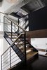 Modern home with Staircase, Wood Tread, and Wood Railing. The switchback stairs create a circulation pattern that, according to Bangia, is "noticeably different than what you would find in a typical Brooklyn town house." She adds, "It lends an element of surprise when moving between floors, and a dynamic spatial sense of expansion and contraction.” Photo of Ever Dream of Taking Over Your Neighbor’s Apartment?
