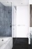 Modern home with Bath Room, Undermount Tub, Enclosed Shower, Corner Shower, Ceiling Lighting, Ceramic Tile Wall, Slate Floor, and Marble Counter. The ensuite master bathroom features Ann Sacks slate floor tile, contrasted with white Carrara marble that wraps the Kohler Tea for Two tub. The shower features tile from Heath Ceramics. Photo of Ever Dream of Taking Over Your Neighbor’s Apartment?