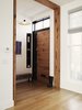 Modern home with Doors, Wood, Swing Door Type, and Exterior. A common theme of the remodel was the incorporation of salvaged material, both from the original house and outside sources. Collaborating with Peter Buley of Analog Modern, the original hemlock fir joists of the house were repurposed into the main entry door. Adjacent to the door is a bench made from a heart pine beam, sourced by Buley. The beam had been charred during a circa-1900 fire, and subsequently painted over during the last 100 years. The unique piece now finds its home in the entry foyer. Photo of It's Back to Basics for This 1901 Brooklyn Town House