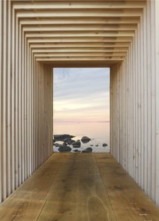 Kajakhuset by In Praise of ShadowsThis "kayak house" is a sleek boathouse with a utilitarian interior that can be adapted for myriad other uses. Constructed like Legos from similar pieces of wood, the structure is capped by two glass doors.