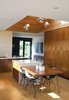 Modern home with Kitchen, Pendant Lighting, Wood Cabinet, and Cooktops. Bill Thompson’s Hollywood home exudes modern cool with a custom walnut dining table and chairs from Modernica. Photo of Material Focus: Custom Walnut Designs