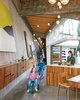 Modern home with Kitchen, Wood Cabinet, Concrete Floor, and Pendant Lighting. Omer Arbel, the creative director at industrial design firm Bocci, was given three parameters when he began designing a home for his colleague Randy Bishop: Create a “profound” connection between the internal and external spaces; build only one level; and, most crucially, utilize a wealth of 100-year-old beams salvaged from a series of warehouses owned by Bishop’s ancestors. Photo 2 of 23.2 House