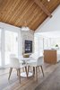 New skylights and a wall of windows fill the open-plan area with light. A two-way indoor/outdoor stone fireplace enhances the home's connection to nature. Photo of Hard to Believe This Home Dates Back to the 1820s modern home