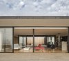 Aluminum lines the glass windows that divide the living spaces from the airy patio. Photo 3 of Unplugged modern home