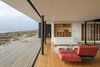 “The transparency and continuity of the spaces allows the landscape, the coast, and the sea to be present at all times,” LLaumett says. While most of the home’s furniture was constructed on site, a sofa by The Popular Design sits in the living room. Photo 4 of Unplugged modern home