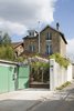Situated on the far end of a driveway and in close proximity to railway tracks, the renovation of this grindstone home had two objectives: make the living areas feel spacious and conceal commuter sights and sounds as much as possible. Photo of Wisteria Residence modern home