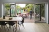 Modern home with Dining Room, Table, Floor Lighting, Light Hardwood Floor, and Chair. When the family wants to eat meals inside, they can sit around the dining table on Eames chairs. Photo 3 of Wisteria Residence