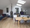 Velux skylights open the extension further. A wood stove by Max Blanks warms the area between the living room and kitchen when the sun is hidden. Photo 4 of Wisteria Residence modern home