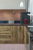 Carocim tiles and custom wood cupboards add lively details to the kitchen’s contained space. Photo 6 of Wisteria Residence modern home