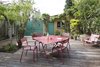 A dining set by Fermob, featuring Luxembourg chairs, makes alfresco meals easy. Photo 8 of Wisteria Residence modern home
