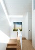 Modern home with Hallway and Medium Hardwood Floor. Curtiss describes the floor plan as “super efficient but with gracious moments.” Instead of maximizing room size, she ensured that shared spaces were adequately sized. In the upstairs hallway, that means two or three people can pass each other with relative ease. Photo of One Bedroom Became Three in This Space-Efficient San Francisco Renovation