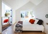 Modern home with Bedroom, Bed, and Wall Lighting. In the master bedroom, the gable roof and balcony foster the illusion of generous space. A free-standing wall divides the sleeping space from the bathroom. Photo of One Bedroom Became Three in This Space-Efficient San Francisco Renovation