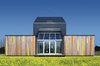 Modern home with Exterior, Green Roof Material, and House. The sun shines over the meadow on the backside of Kuczia’s carbon-saving creation, whose central atrium contains the living room. In summer, the glass doors open. Photo of 16 Funky Facades