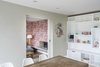 A wood-burning stove warms the sitting room. Its chimney gives the home a profile in-line with the other houses in the area. Photo of Think a Victorian Villa Can't Be Made Modern? Think Again modern home