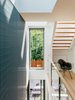 Modern home with Staircase and Wood Tread. The laneway house features Kentwood engineered-wood floors, Cascadia windows, and aluminum-bar grating. The Eames DAX chair is vintage. Photo of Modern Spaces in the Pacific Northwest