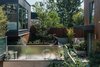 Modern home with Outdoor, Walkways, and Side Yard. The “mid-ground” between the three structures serves as a community hub. Dick takes advantage of the site’s shared bicycle storage and its proximity to a popular bike lane. Photo of Modern Spaces in the Pacific Northwest