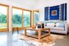 The architect wanted the stunning views to take center stage, selecting a neutral color palette. The polished concrete, in addition to storing the sun’s warmth and passively heating the space, reflects sunlight upwards to illuminate the living room. Photo 5 of Off-Grid Retreat modern home