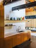 Modern home with Kitchen, Dark Hardwood Floor, Wood Cabinet, Undermount Sink, Track Lighting, Ceramic Tile Backsplashe, and Open Cabinet. Helgerson selected white Savoy 1”x4” stacked tiles from Ann Sacks for both the kitchen and bathroom. Photo of 50+ Modern Tile Ideas for Walls, Floors and Ceilings