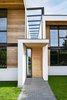 In front, a stone walkway leads a covered entrance. Photo 3 of Wrap House modern home