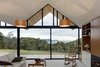 Modern home with Living Room, Chair, Pendant Lighting, and Sofa. A Shaker-inspired rocking chair by Hans Wegner exudes country charm in the corner of the living room. Photo of These Modern Glass Homes Shatter Conventions