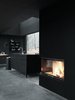 Modern home with Kitchen. Heating for the unit is provided by a Spartherm fireplace, with electric heating integrated into the magnesite floor. Walls are insulated with fire-tested wool felt under plywood panels. Photo of Prefab Gets a Makeover With Danish Industrial Design