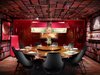 Modern home with Dining Room, Chair, Table, Pendant Lighting, and Dark Hardwood Floor. Jaleo (Las Vegas, Nevada)
An intimate dining area for eight influenced by Spanish surrealism is the Las Vegas Jaleo’s most outstanding feature. The space, designed by Rockwell Group, features black leather Showtime Chairs by Jaime Hayon that pair with a walnut table by Ian Ingersoll. The custom bookshelf wall coverings are by MDC. Photo of The 10 Best-Designed Restaurants in America