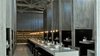 Modern home with Dining Room, Pendant Lighting, Concrete Floor, Bench, Chair, and Table. Workshop Kitchen + Bar (Palm Springs, California)
Instead of the midcentury style so popular in Palm Springs, Workshop Kitchen + Bar opts for a bold mix of industrial and ecclesiastical design. Concrete “side chapels” flank a communal table underneath a 27-foot peaked ceiling. The exposed pendant lights are by .PSLAB. Photo of The 10 Best-Designed Restaurants in America