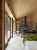 The cabin was designed so that the north half can be closed off when not in use to reduce energy consumption. When the northern half is closed, the radiant floor heating can be turned off and the main area can be heated by the high efficiency wood fireplace. Photo by Shai Gil. Photo 4 of Stealth Cabin modern home