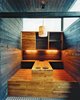 The kitchen table, built into the structure of the house, includes two hot plates. Rintala says these were inspired by the Korean way of cooking: Residents and guests will cook their own food at the table. Photo of Cozy Scandinavian Abodes modern home