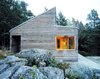 Modern home with Outdoor, Wood Siding Material, House Building Type, Boulders, Side Yard, Large Patio, Porch, Deck, and Wood Patio, Porch, Deck. Woody35's distinct shape makes it stand out from its surroundings despite the modest size of the building. Photo of Cozy Scandinavian Abodes