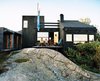 Modern home with Outdoor, Back Yard, and Small Patio, Porch, Deck. “People scold us if we don’t raise the kite,” says Holm (sitting with Kiehl,). From the bench outside, the couple can wave to friends passing in boats and make use of the long summer evenings. Photo of Creative Modern Porches and Decks