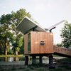 Modern home with Exterior, Cabin Building Type, Wood Siding Material, Small Home Building Type, Tiny Home Building Type, and Butterfly RoofLine. Perched above a pond on 14 acres in Champaign, Illinois, this hut was designed for enjoying tea and meditation. Dominating the 97-square-foot structure is a butterfly roof, which channels rainwater to a central spout to be directed to the pond. Adding to the zen experience are water reflections that are projected onto the soffit throughout the day. Photo of Butterfly Roof Meditation Hut