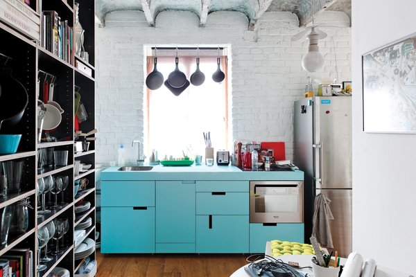 The budget was nearly as tight as the space in this cheerful renovation of a 516-square-foot flat in Bratislava. The centerpiece of Lukáš Kordík’s new kitchen is the cabinetry surrounding the sink, a feat he managed by altering the facing and pulls of an off-the-rack Ikea system. The laminate offers a good punch of blue, and in modernist fashion, Kordík forwent door handles in favor of cutouts. “I wanted the kitchen to be one simple block of color without any additional design,” he says.