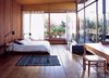 Modern home with Bedroom, Bed, Medium Hardwood Floor, and Table Lighting. A COZY AND MODERN INDOOR-OUTDOOR BEDROOM IN BUENOS AIRES
In Argentinean architect and furniture designer Alejandro Sticotti's bedroom, dappled sunlight and reclaimed-wood floors and walls give the room a warm, peaceful feel. Photo of Fall Design Trend: Warm Woods