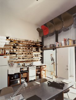 The computer-designed kitchen area has the feel of a ship's galley, with everything neatly stowed, yet visible and instantly at hand: It's much the definition of "ship-shape." For dinner parties, well-worn Eames shell chairs are pulled down by David, with the help of a footstool. "I have nearly an eight-foot reach," says the 6'3'' David. ("It gets a little tough if I have to spend a weekend or so alone," says Im.)